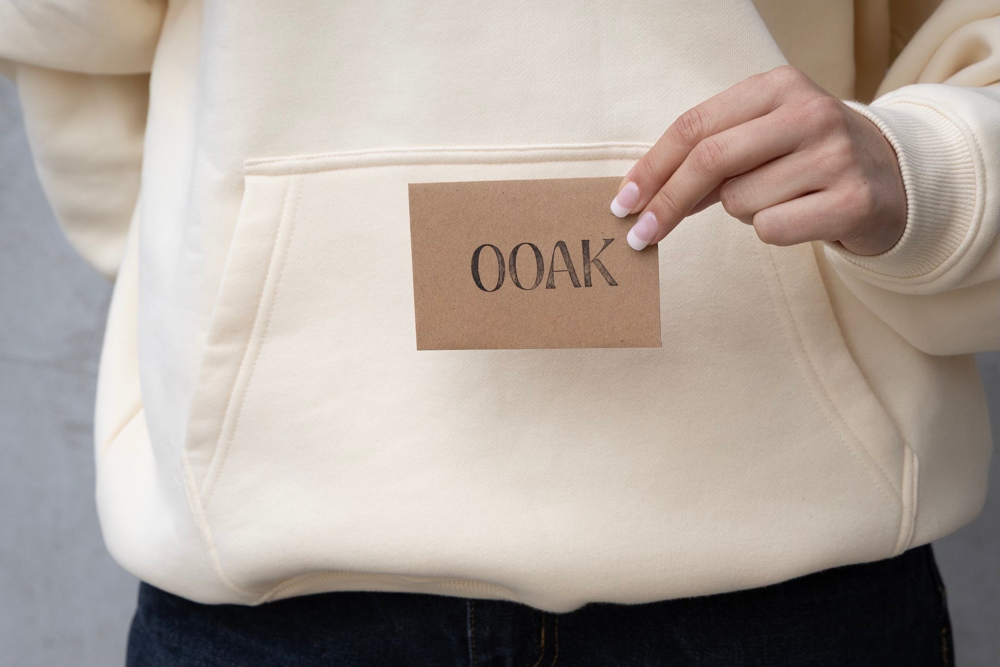 Beige hoodie with a 'OOAK' label on a gray background