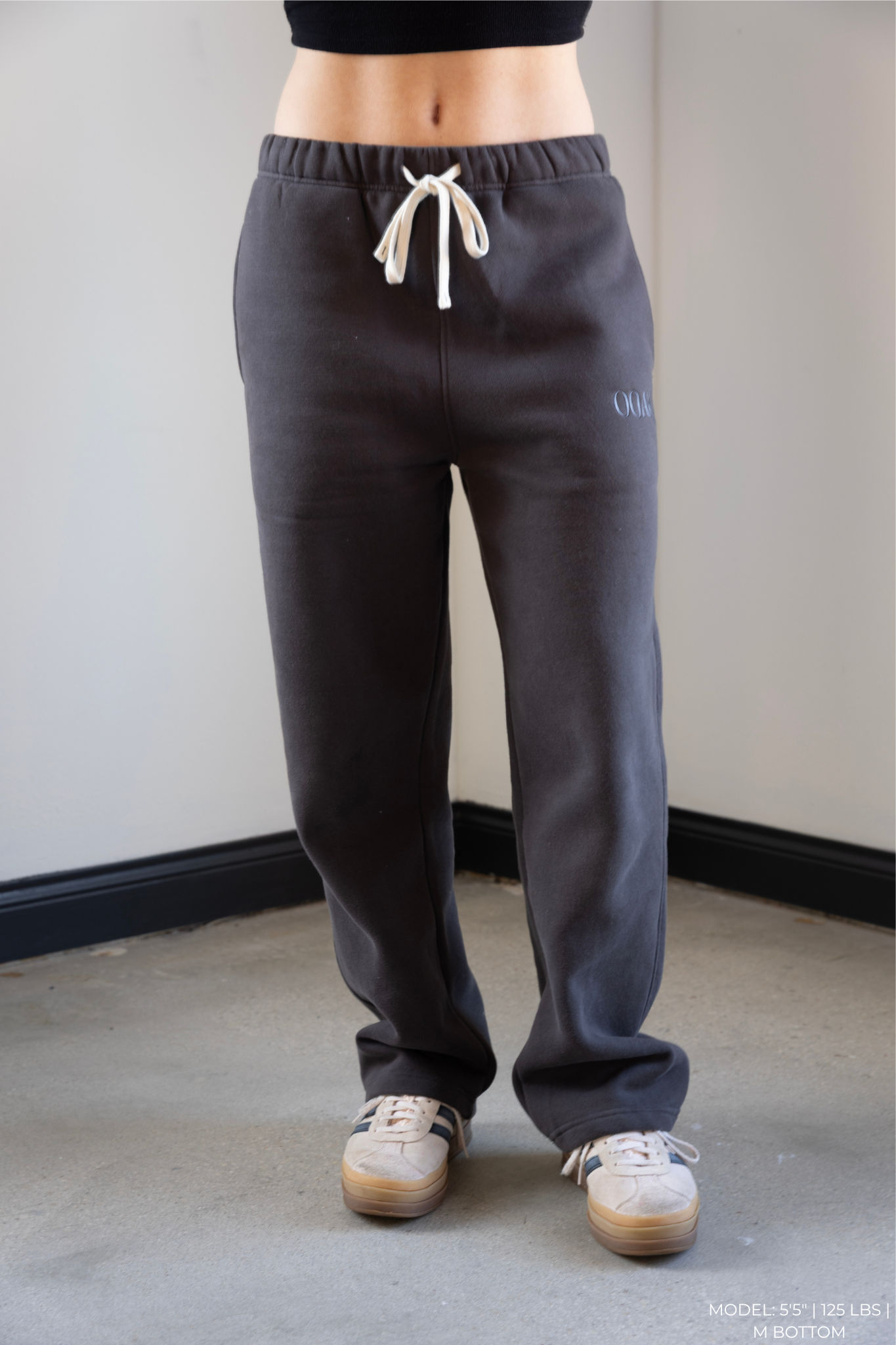 Model wearing gray OOAK sweatpants with a white background